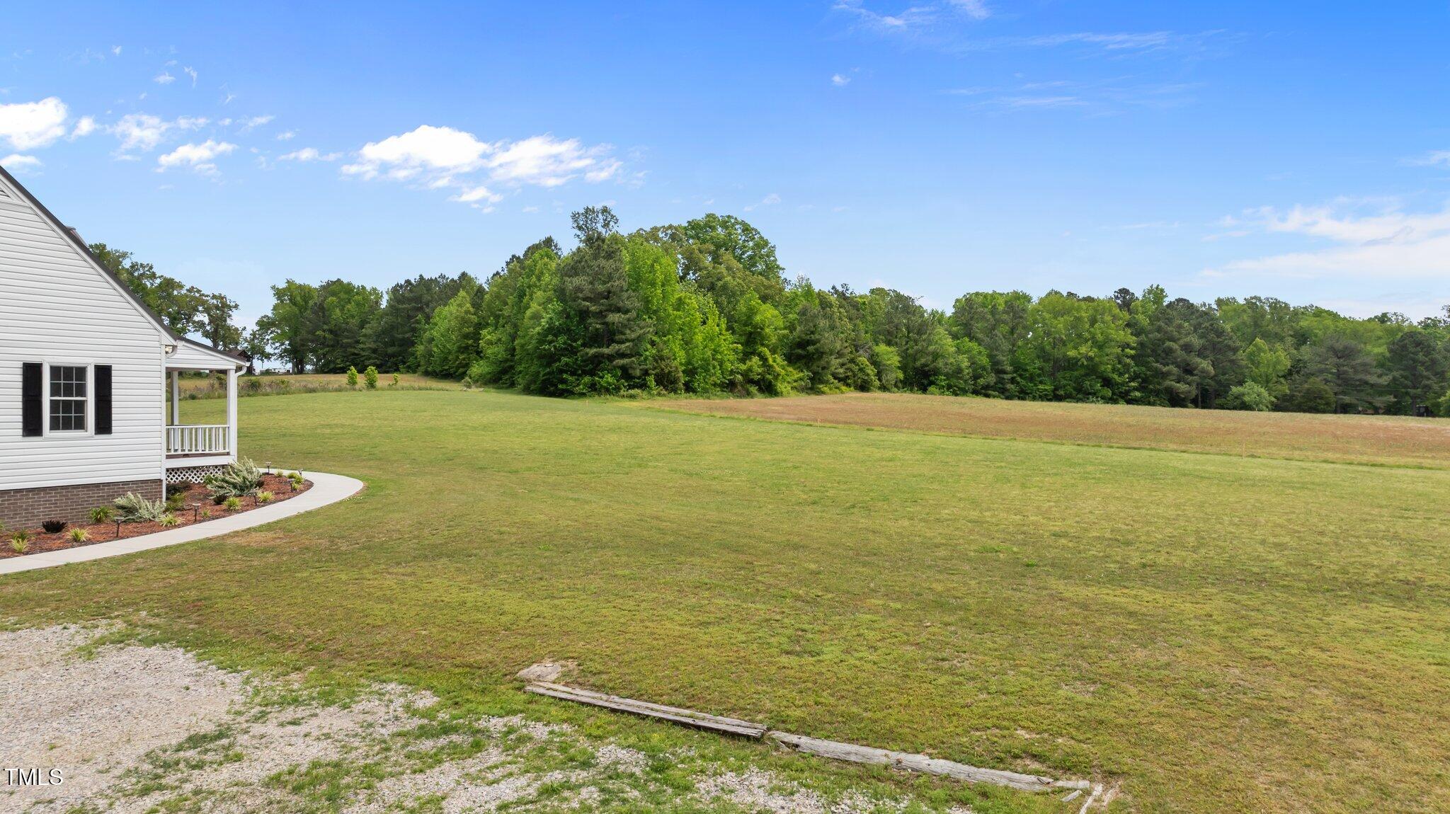 675 Anderson Creek Road Henderson, NC 27537 - Photo 17 of 62 a view of a large pool with lawn chairs and large tree