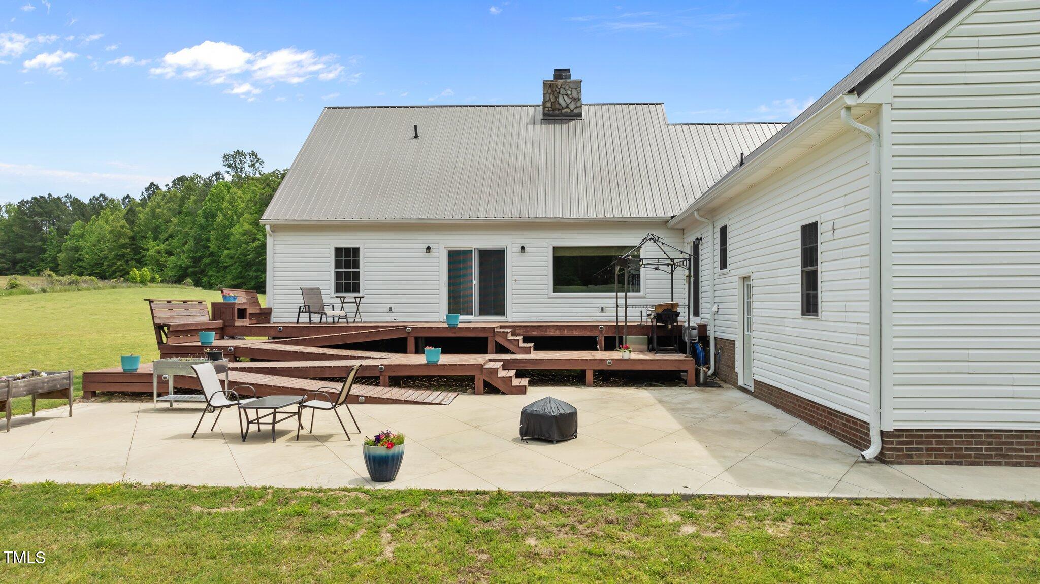 675 Anderson Creek Road Henderson, NC 27537 - Photo 22 of 62 a view of a house with swimming pool and sitting area