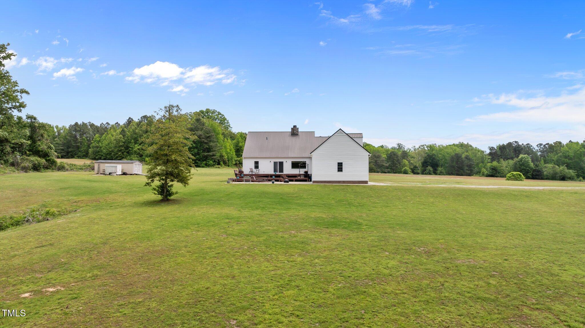675 Anderson Creek Road Henderson, NC 27537 - Photo 24 of 62 a front view of a house with garden