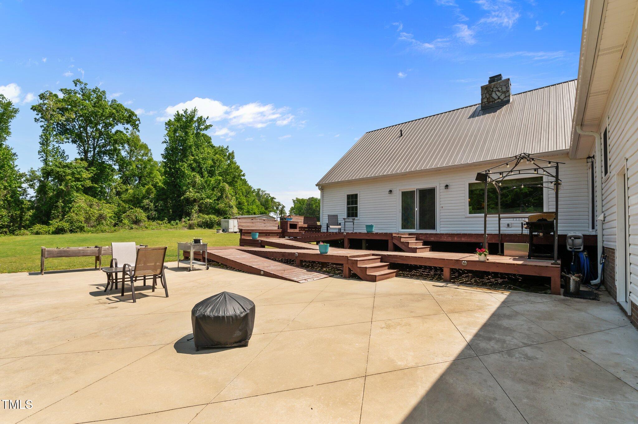 675 Anderson Creek Road Henderson, NC 27537 - Photo 30 of 62 a view of a patio with swimming pool table and chairs