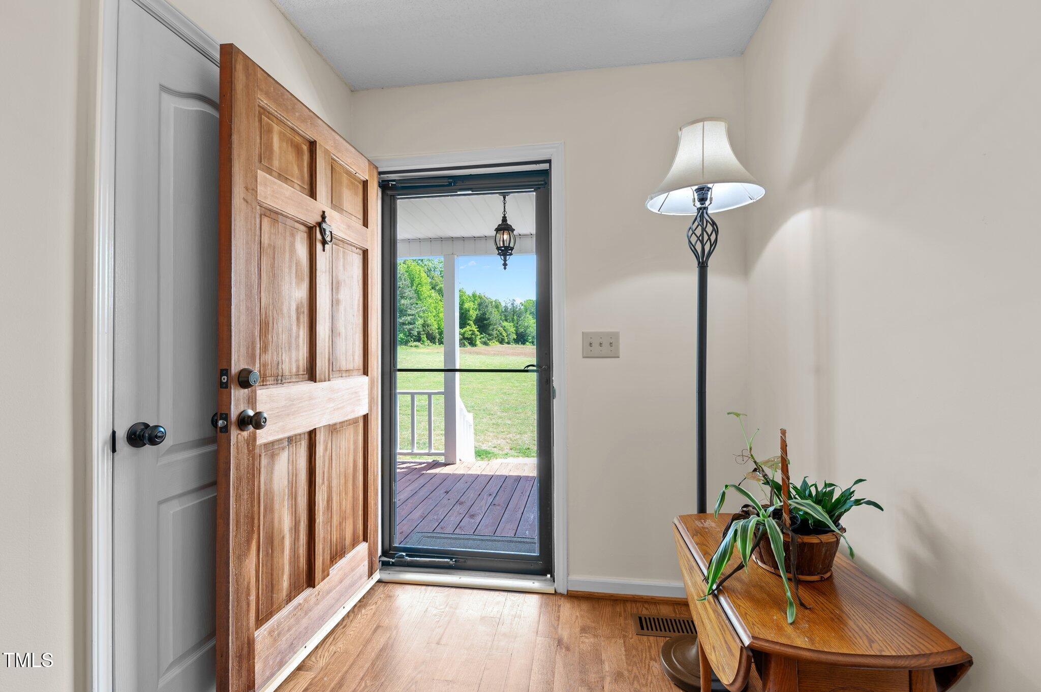 675 Anderson Creek Road Henderson, NC 27537 - Photo 31 of 62 a view of a room with a floor to ceiling window and wooden floor