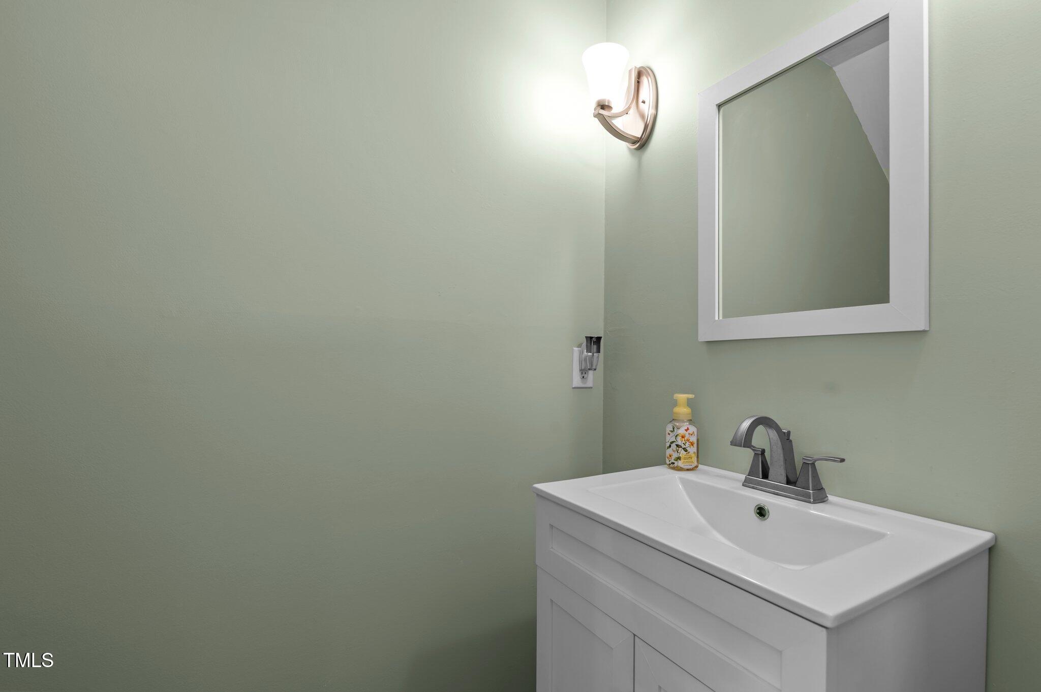 675 Anderson Creek Road Henderson, NC 27537 - Photo 33 of 62 a bathroom with a sink and mirror