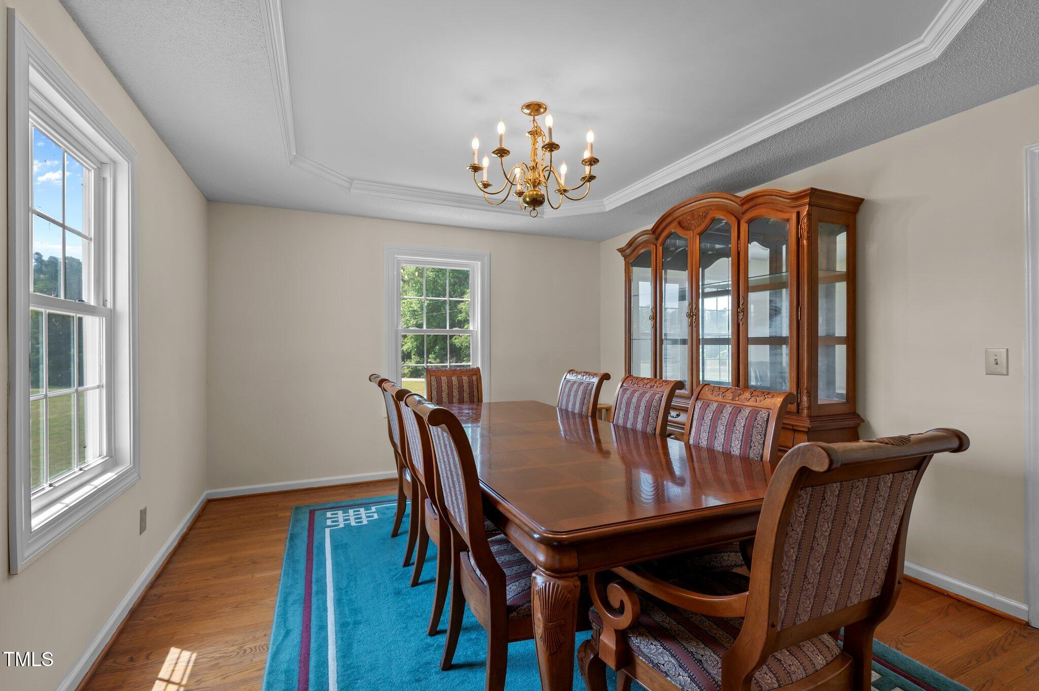 675 Anderson Creek Road Henderson, NC 27537 - Photo 36 of 62 a view of a dining room with furniture a chandelier and wooden floor