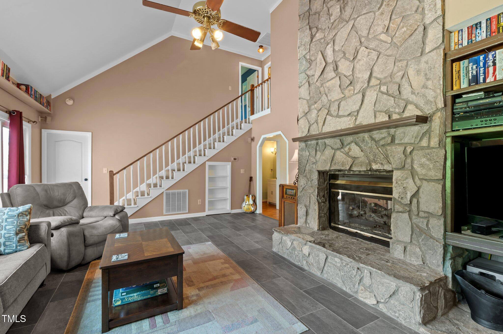 675 Anderson Creek Road Henderson, NC 27537 - Photo 44 of 62 a living room with fireplace furniture and a flat screen tv