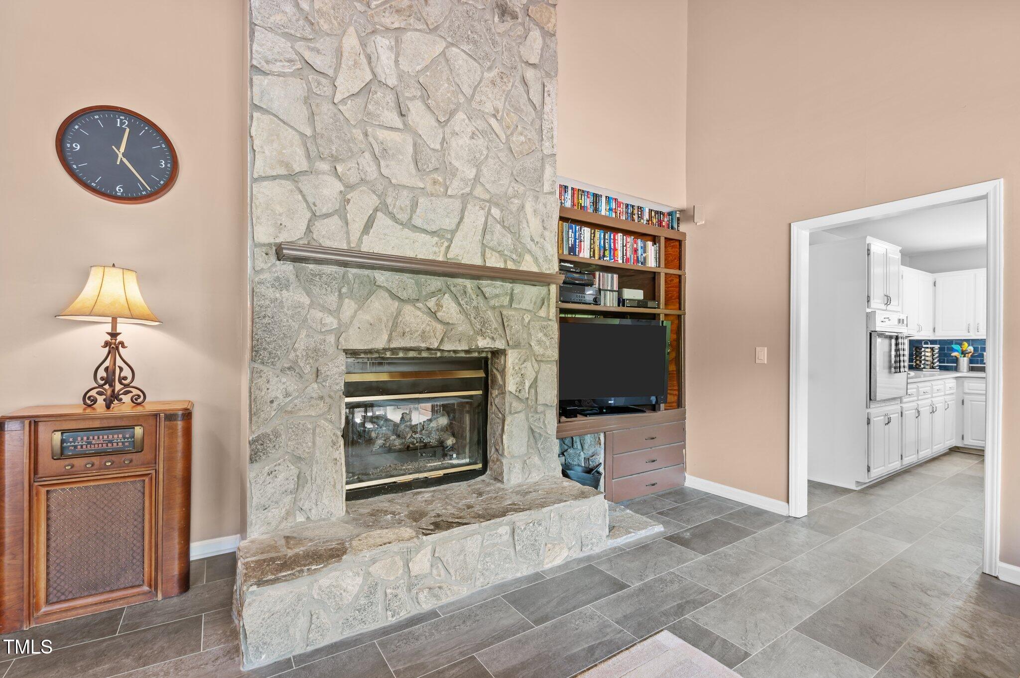 675 Anderson Creek Road Henderson, NC 27537 - Photo 46 of 62 a living room with furniture and a fireplace