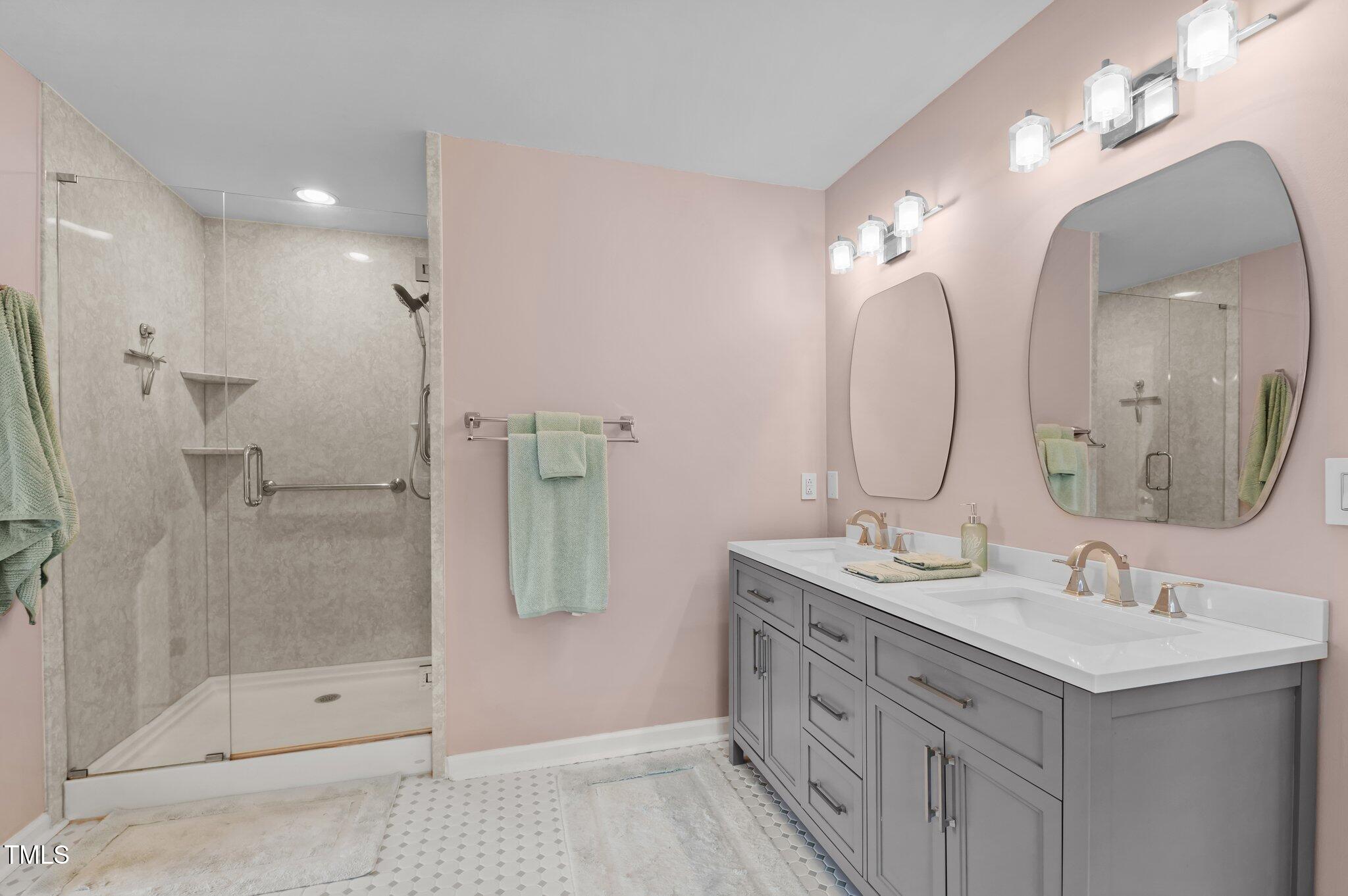 675 Anderson Creek Road Henderson, NC 27537 - Photo 49 of 62 a bathroom with a double vanity sink mirror and shower