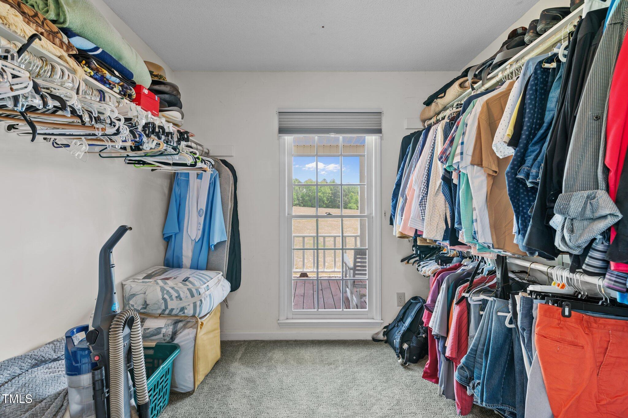 675 Anderson Creek Road Henderson, NC 27537 - Photo 52 of 62 a view of walk in closet with clothes