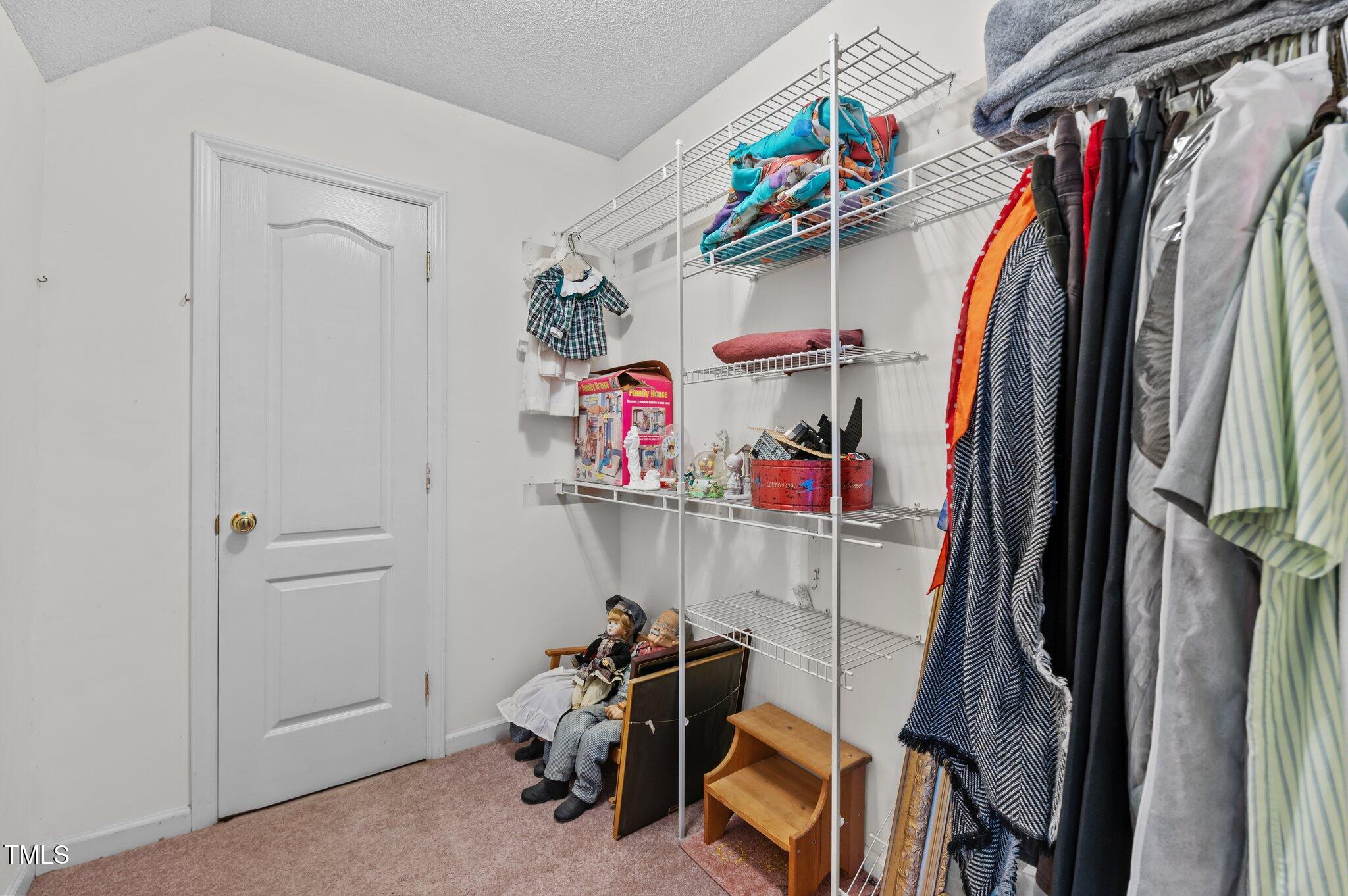 675 Anderson Creek Road Henderson, NC 27537 - Photo 57 of 62 a view of walk in closet with clothes and shoes