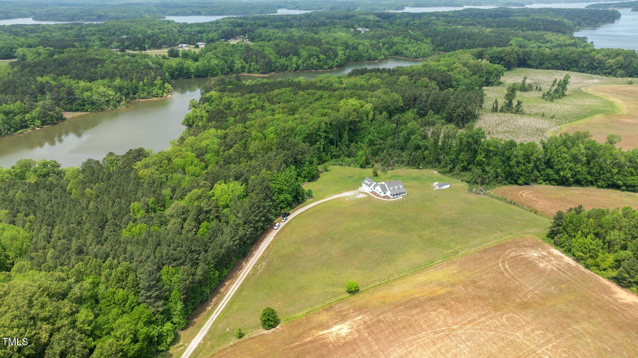 675 Anderson Creek Road Henderson, NC 27537 - Photo 8 of 62 an aerial view of a house with a yard and lake view