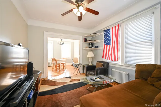 a bedroom with furniture and a flat screen tv