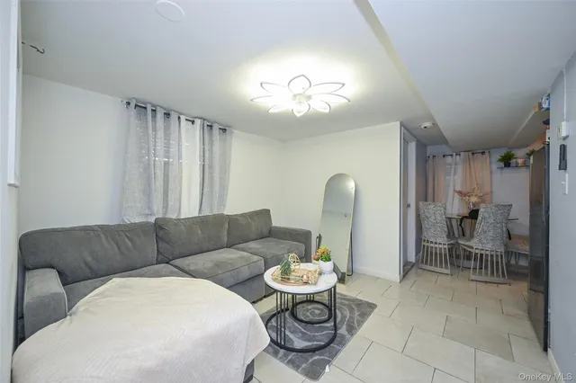 a living room with furniture a table and chairs