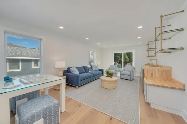 a living room with furniture and a kitchen view