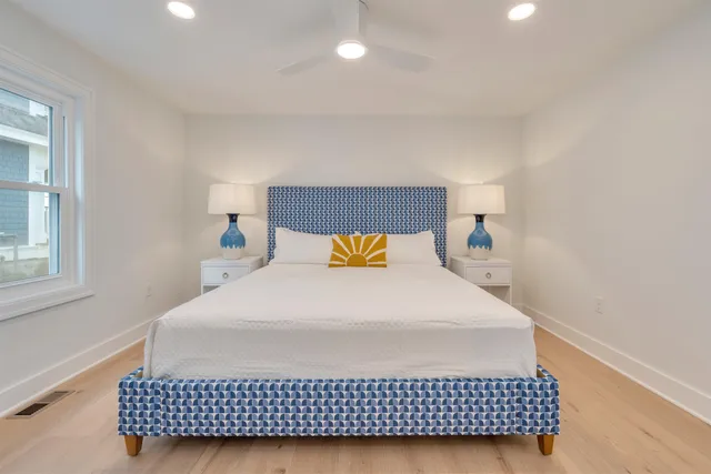 a bedroom with a bed and a window