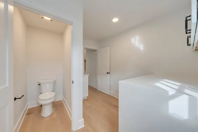 a spacious bathroom with a toilet and a shower