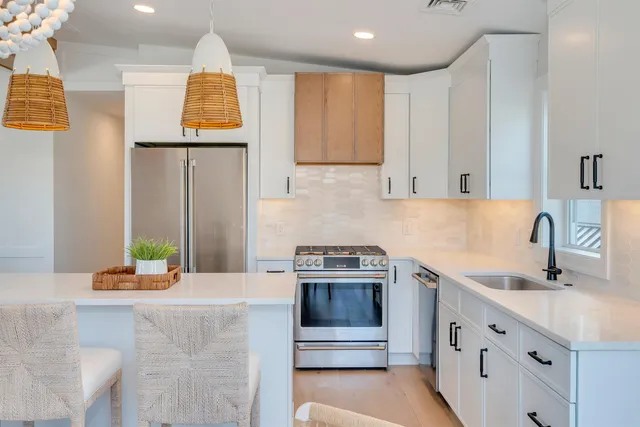 a kitchen with stainless steel appliances granite countertop a sink and a stove