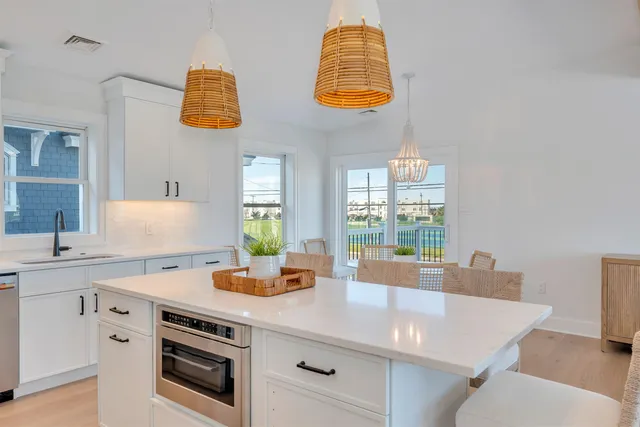 a kitchen with a sink cabinets and a window