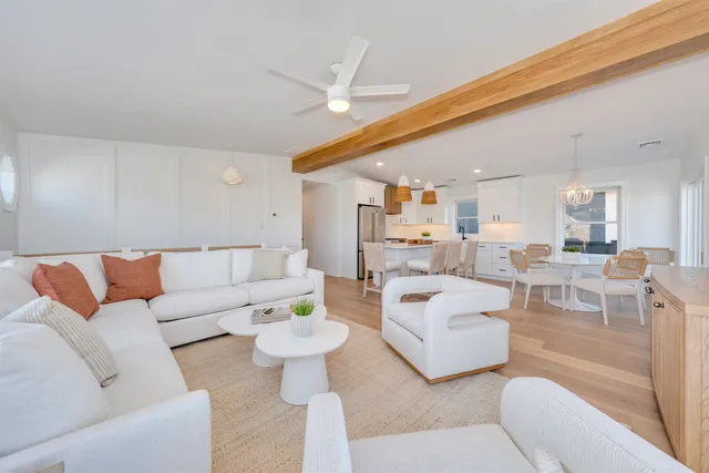 a living room with furniture and a large mirror
