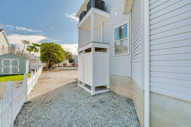 a view of a dining room with furniture a chandelier and wooden floor