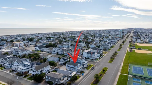 a view of a dining room with furniture a chandelier and wooden floor