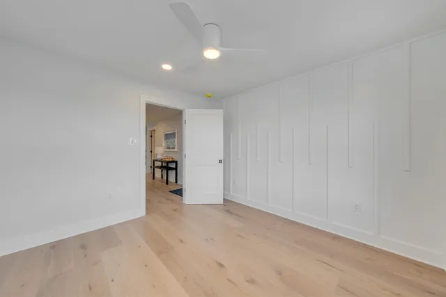 a view of empty room with wooden floor and entryway