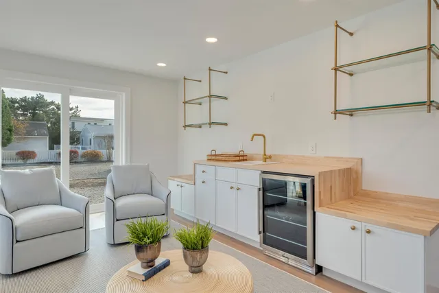 a living room with furniture and a kitchen view