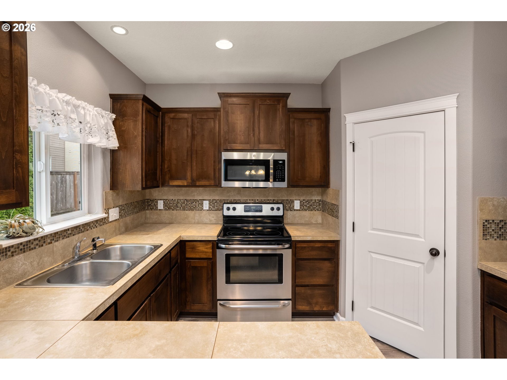 52183 Southeast Tussing Way Scappoose, OR 97056 - Photo 12 of 32 a kitchen with a sink stove and microwave