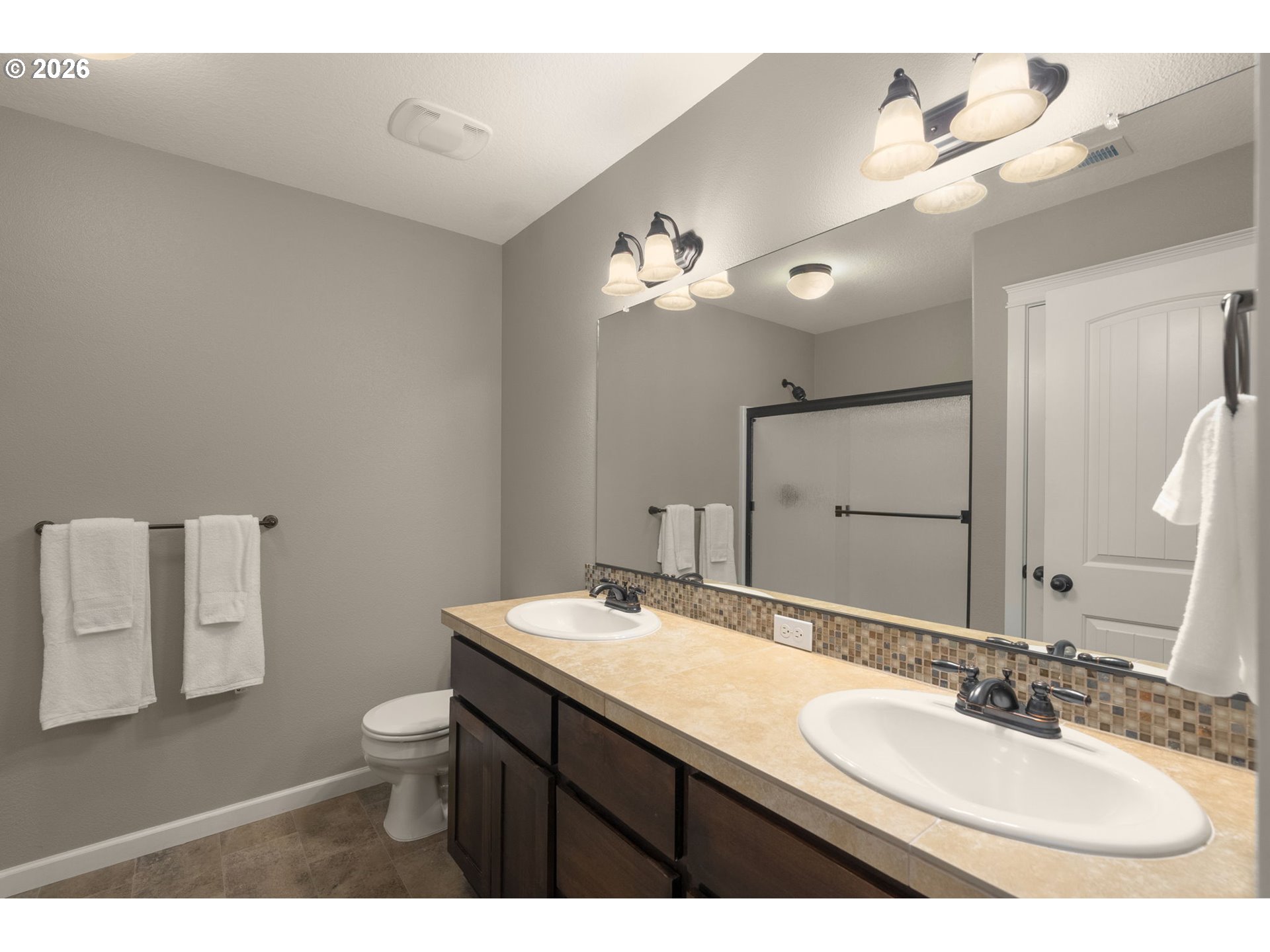 52183 Southeast Tussing Way Scappoose, OR 97056 - Photo 17 of 32 a bathroom with a granite countertop sink a toilet and a mirror
