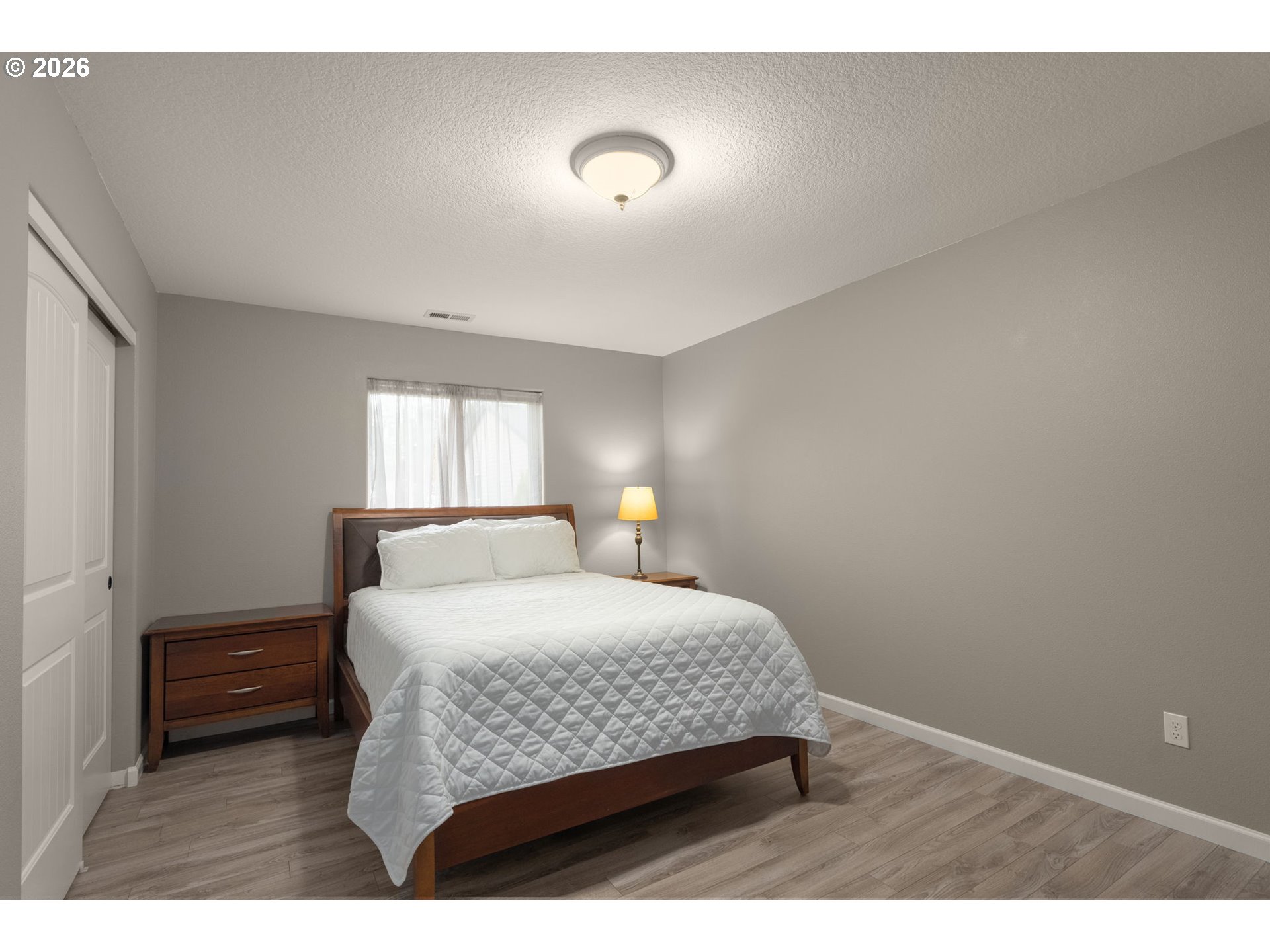 52183 Southeast Tussing Way Scappoose, OR 97056 - Photo 18 of 32 a bedroom with a bed and a lamp