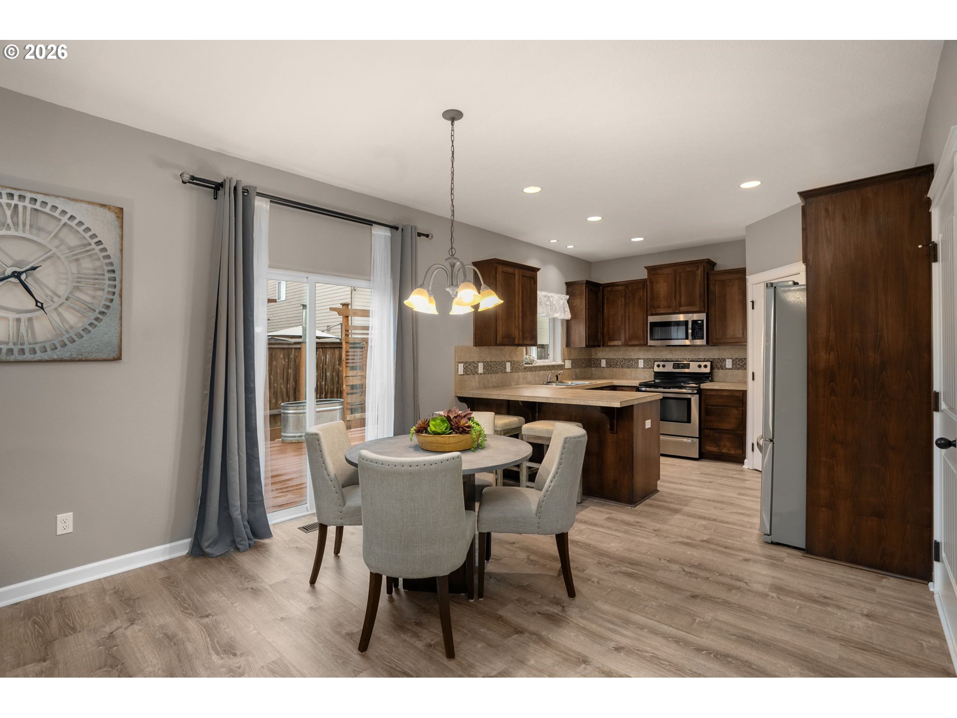 52183 Southeast Tussing Way Scappoose, OR 97056 - Photo 8 of 32 a kitchen with refrigerator a sink and chairs