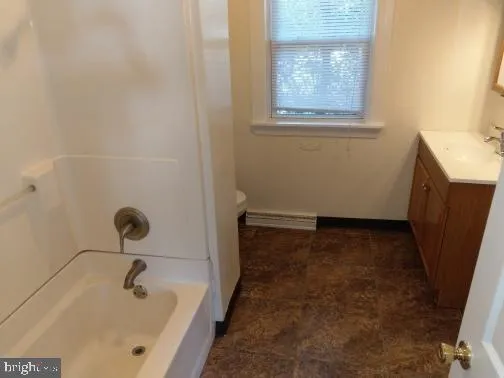 a bathroom with a tub and a window