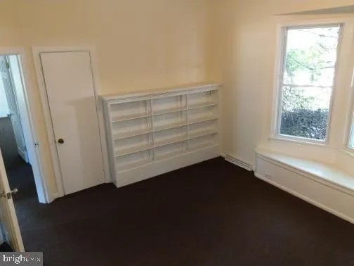 a view of room with hardwood floor and window