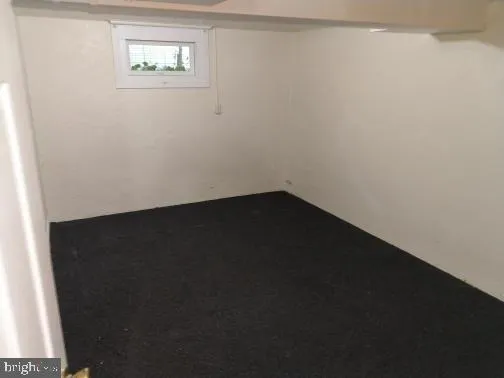 a view of a small space with wooden floor and a window