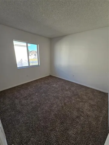 a view of an empty room and closet