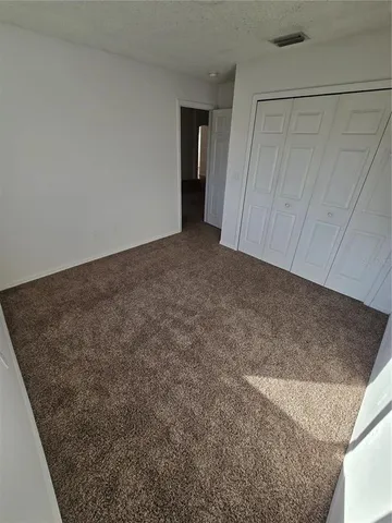 a view of an empty room and a window