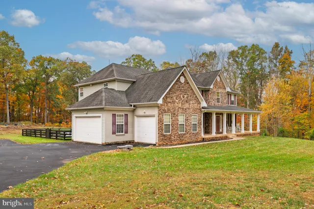 a view of a dining room with furniture wooden floor and chandelier