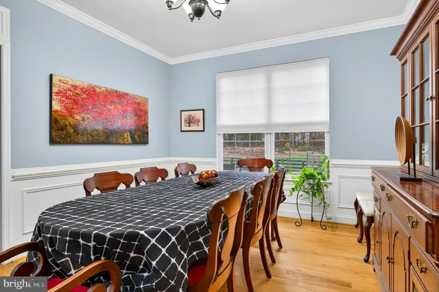 a picture of a room with a white wall and a painting