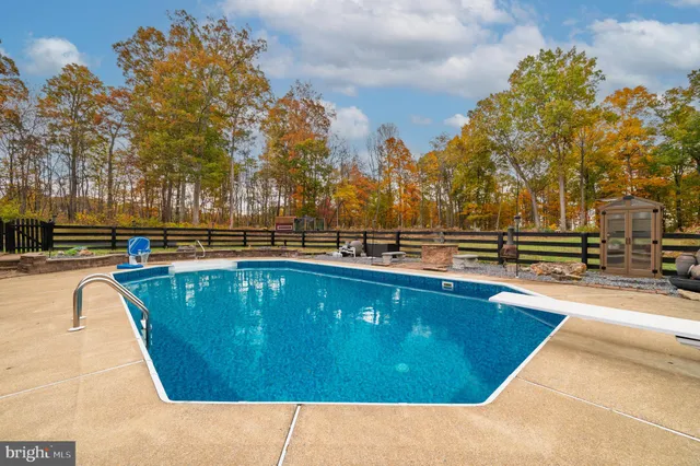 a view of swimming pool with outdoor seating