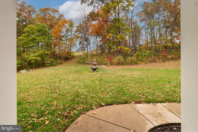 a kitchen with granite countertop a sink a counter top space and living room view