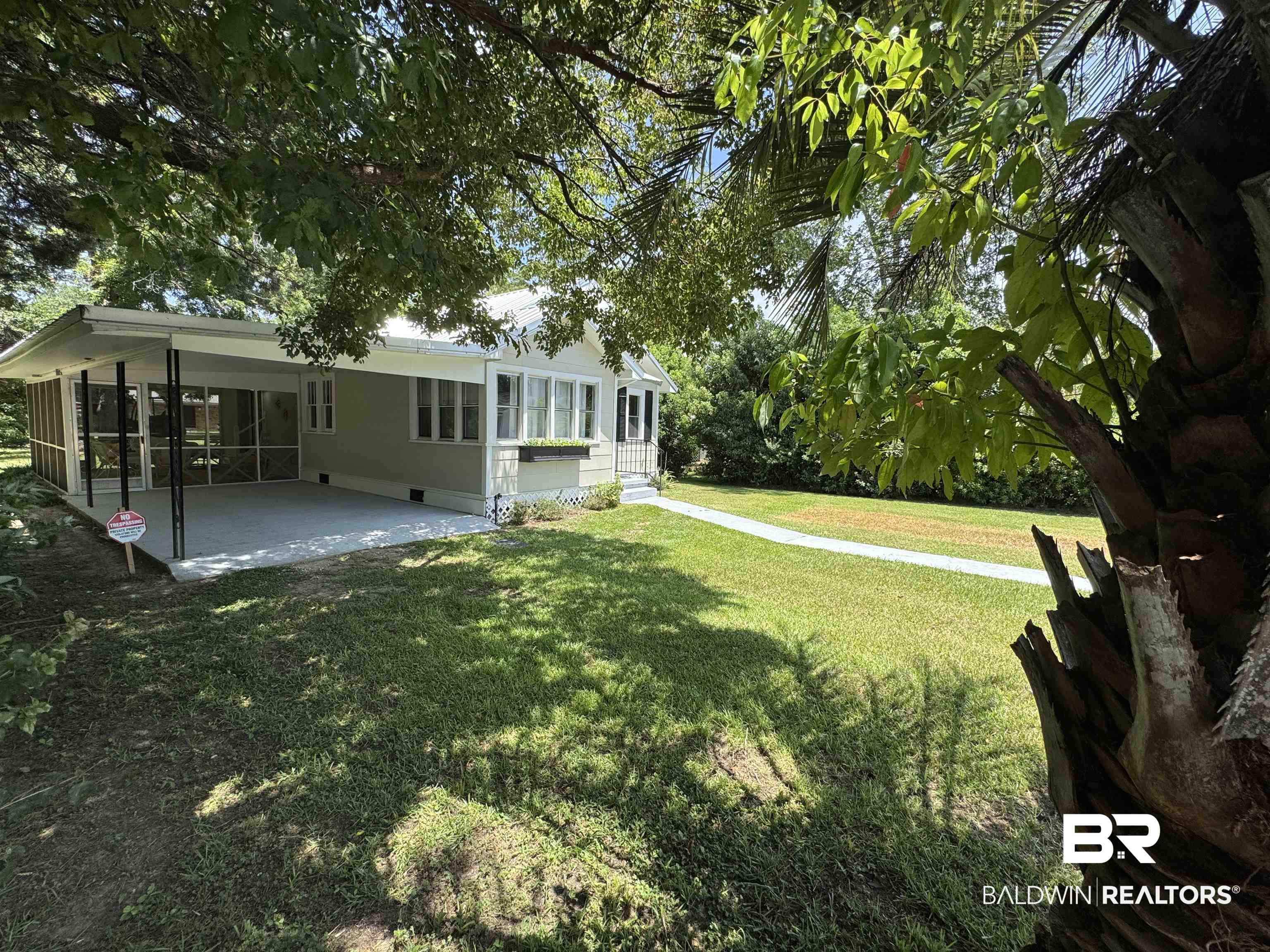 22640 Racine Street Robertsdale, AL 36567 - Photo 3 of 40 View of grassy yard with a sunroom and a patio area