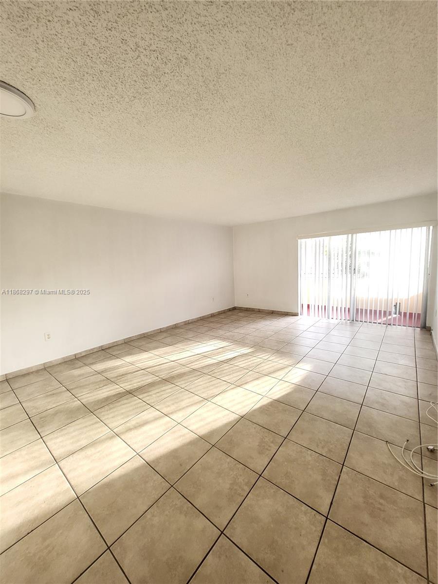 1175 Normandy Drive, Unit 2D Miami Beach, FL 33141 - Photo 11 of 13 a view of an empty room and a window