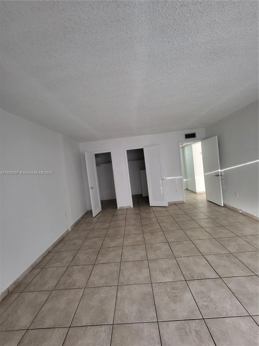 1175 Normandy Drive, Unit 2D Miami Beach, FL 33141 - Photo 5 of 13 a view of an empty room with a window