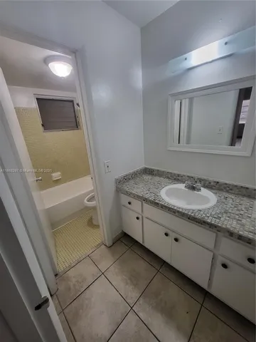 a bathroom with a sink a toilet and bathtub
