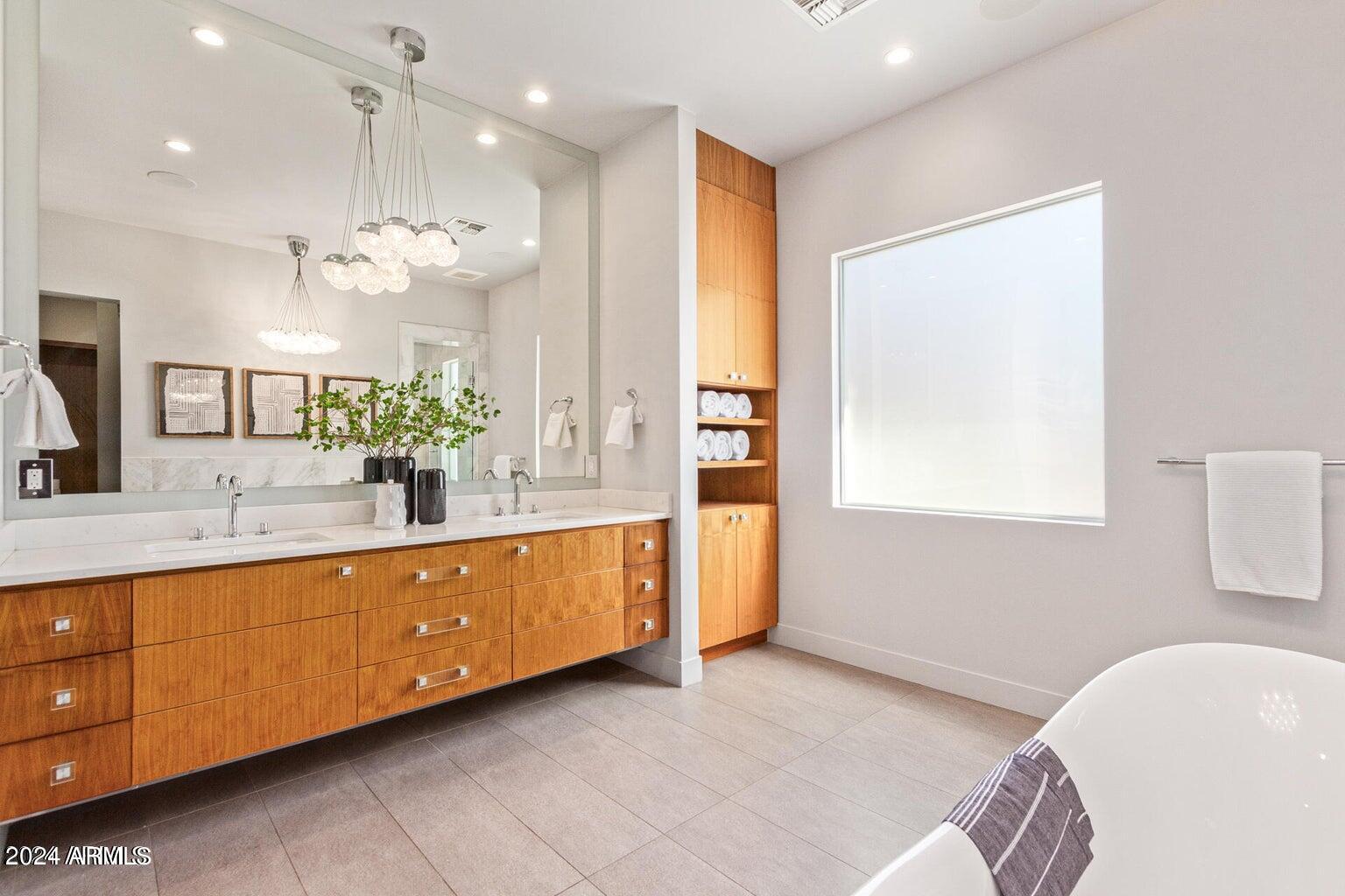 5833 North 46th Street Phoenix, AZ 85018 - Photo 16 of 29 a spacious bathroom with a double vanity sink tub and a mirror