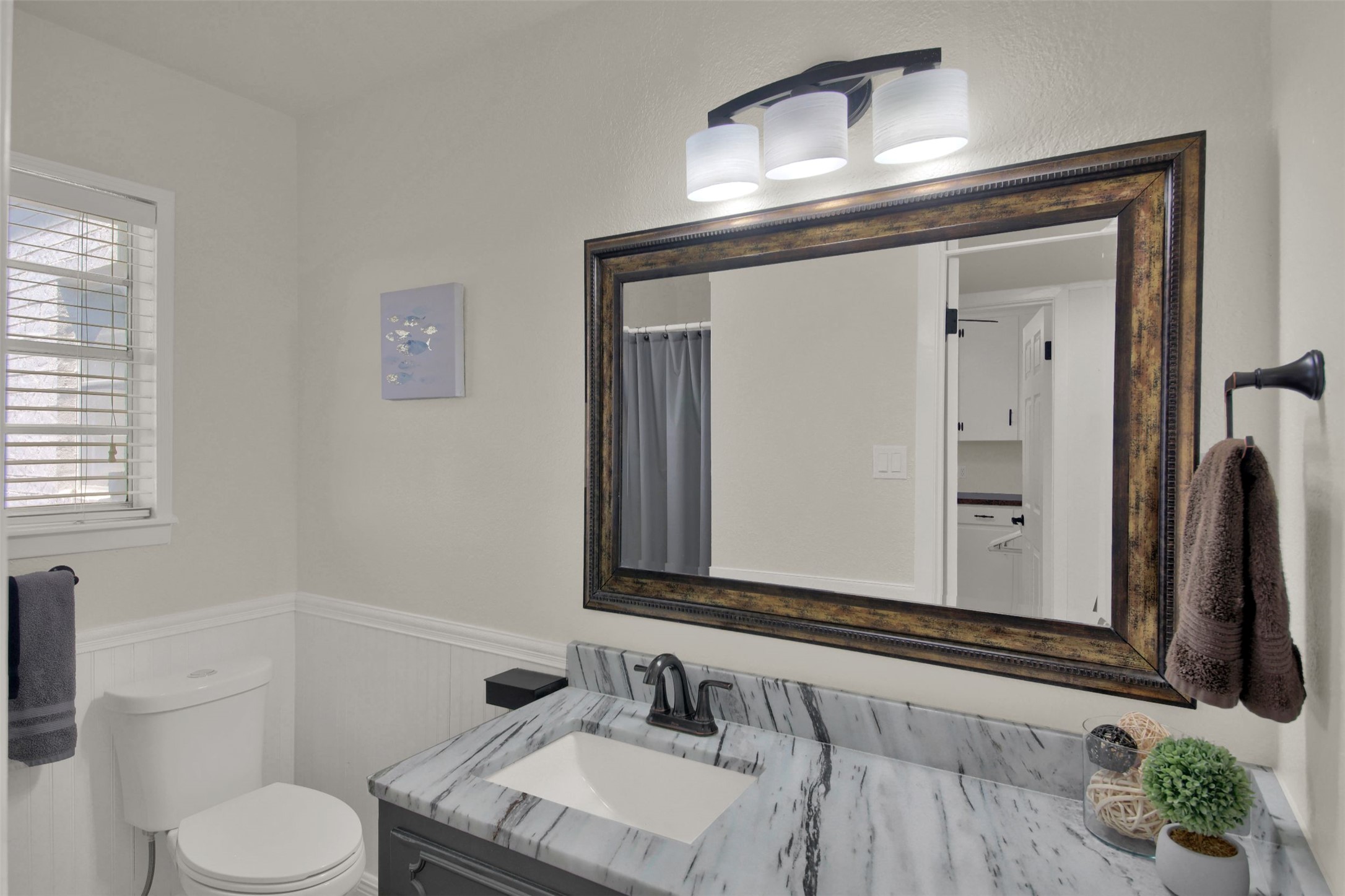 550 C.Bud Stockton Loop Jarrell, TX 76537 - Photo 17 of 37 Bathroom featuring vanity, wainscoting, and curtained shower