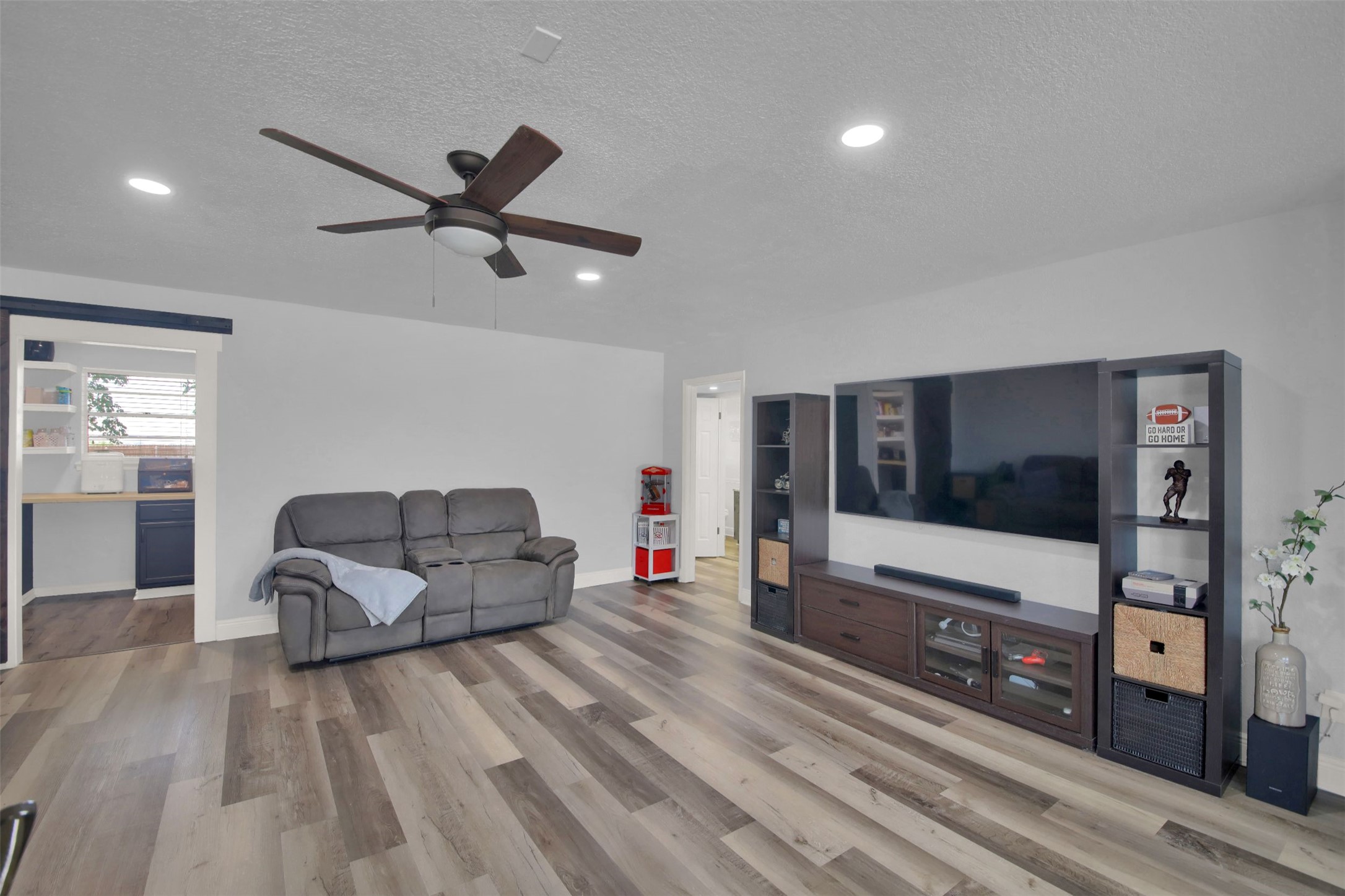550 C.Bud Stockton Loop Jarrell, TX 76537 - Photo 19 of 37 Second living room featuring a textured ceiling, light wood finished floors, recessed lighting, and ceiling fan