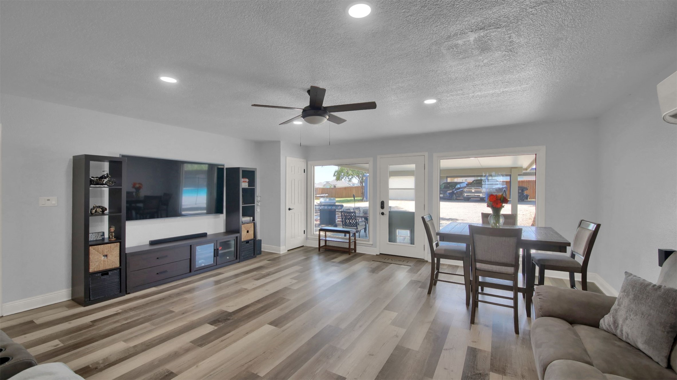 550 C.Bud Stockton Loop Jarrell, TX 76537 - Photo 20 of 37 Living room with light wood-style floors, a textured ceiling, ceiling fan, and recessed lighting