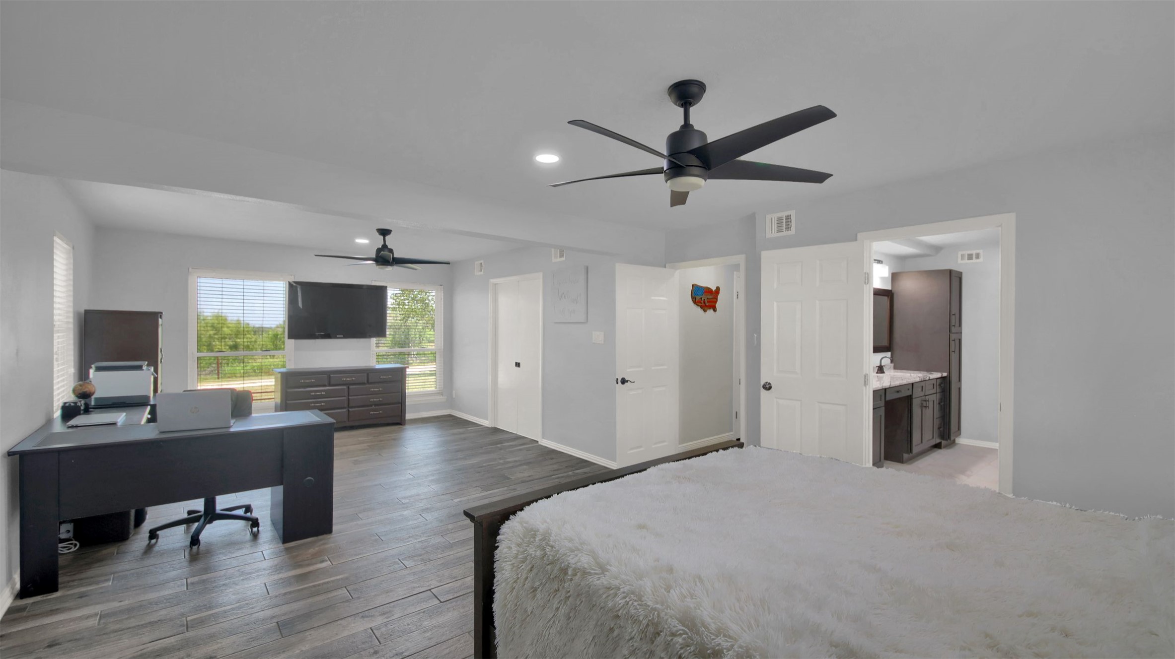 550 C.Bud Stockton Loop Jarrell, TX 76537 - Photo 23 of 37 Primary bedroom featuring an office area, light wood-type flooring, recessed lighting, ensuite bathroom, and a ceiling fan