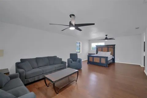 a living room with furniture a ceiling fan and a rug