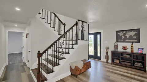 a view of entryway and hall with wooden floor