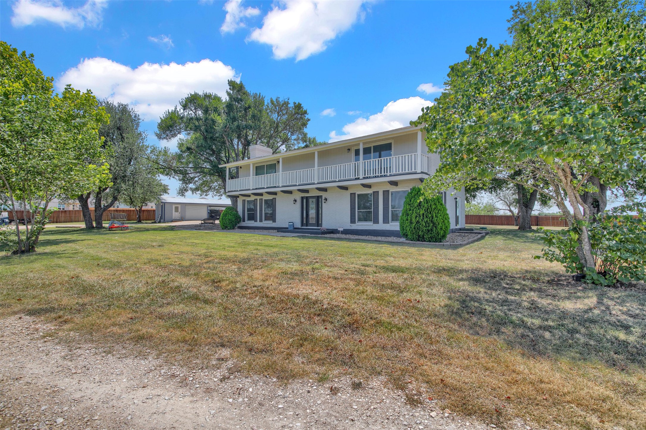 550 C.Bud Stockton Loop Jarrell, TX 76537 - Photo 34 of 37 Back of property with a balcony, a patio area, and a chimney